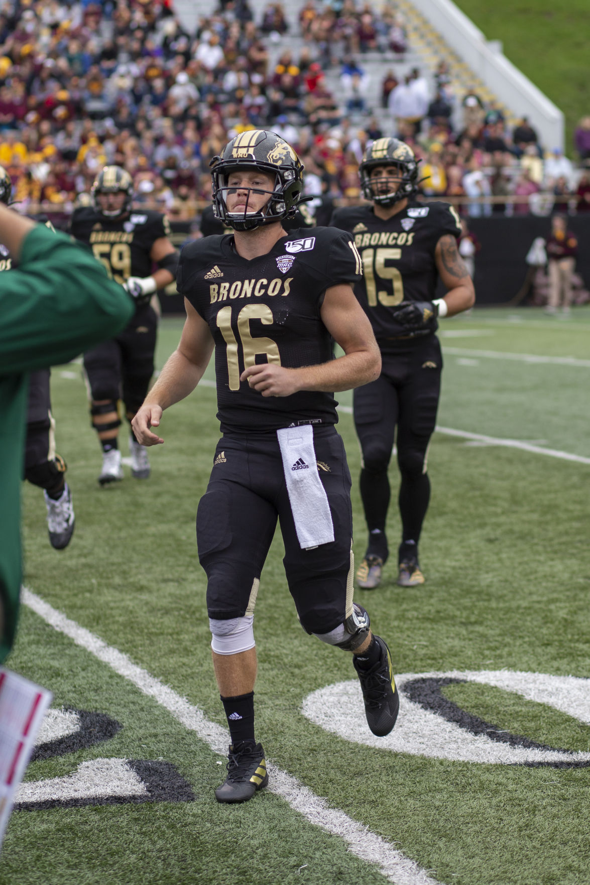 Quarterback Jon Wassink jogs to the sideline during a timeout while up 10-0 against the Central Michigan Chippewas.